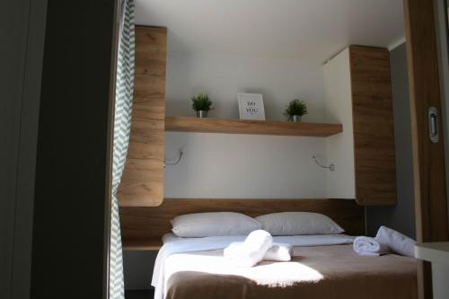 a bedroom with two beds with towels on them at Mobile Homes Katinka, Starigrad Paklenica, Croatia in Starigrad
