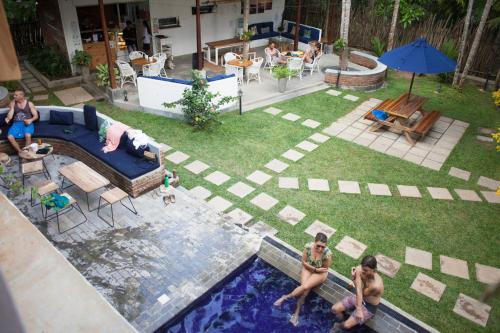 a group of people in a backyard with a pool at Salt House in Hiriketiya