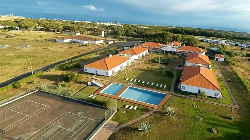 an aerial view of a house with a tennis court at Hotel Santa Maria in Vila do Porto