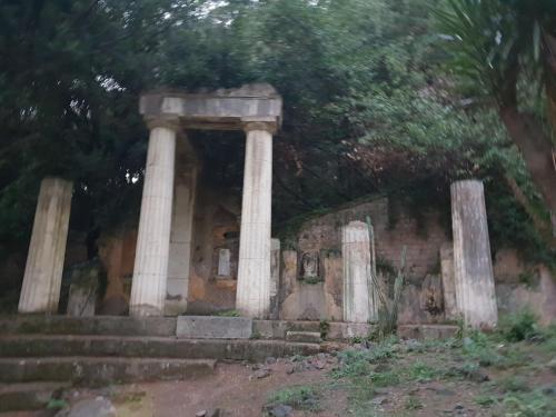 an ancient temple with columns in a forest at Al centro Luxury Home in Caserta