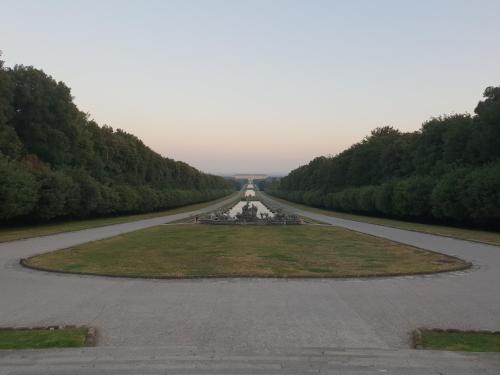 a long road with a fountain in the middle at Al centro Luxury Home in Caserta