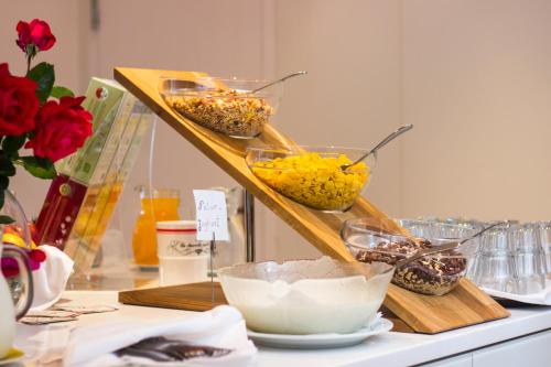 a shelf with bowls of food on a counter at Pension Lichtenburg in Nalles