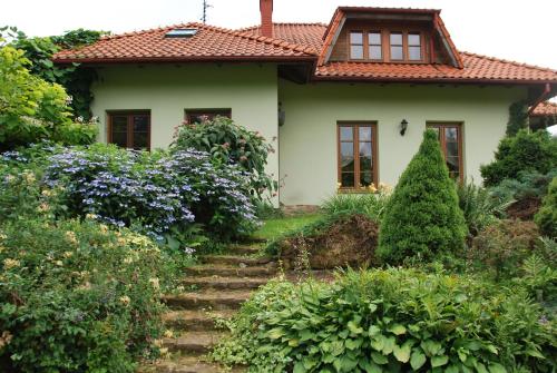 a house with stairs leading up to it at Pensjonacik Ogrody in Pierzchno
