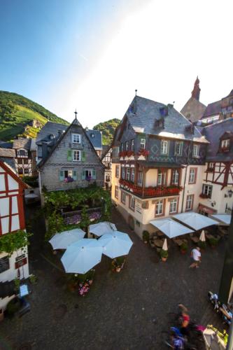 a group of buildings with umbrellas in a town at Villa Beilstein in Beilstein