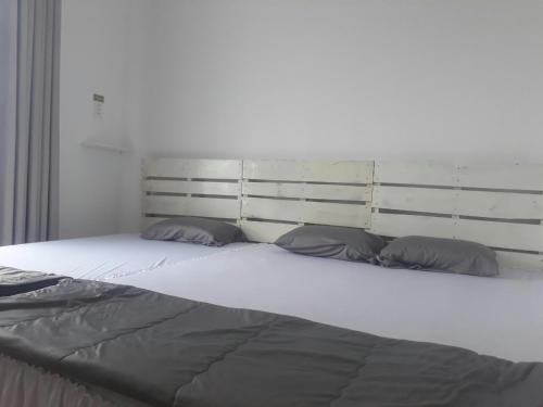 a large white bed with two pillows on it at Lan Thai Ngoc Hotel in Cao Lãnh
