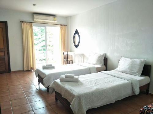 Llit o llits en una habitació de Lomsabai Apartments