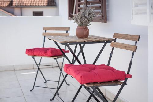 a table with two chairs and a table with red cushions at Central, spacious, great view in Hvar