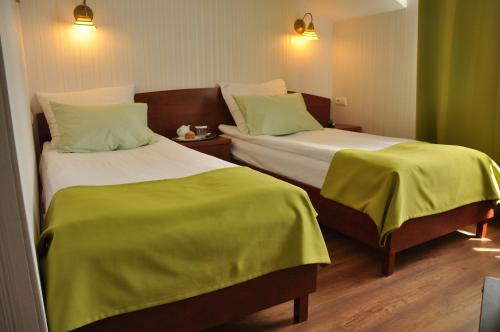 Postel nebo postele na pokoji v ubytování Hotel Leopolis