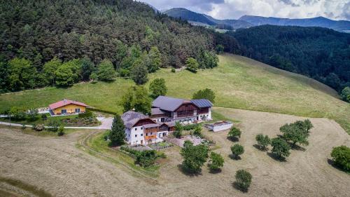 an aerial view of a house on a hill at Appartament Eichnerhof in Chienes
