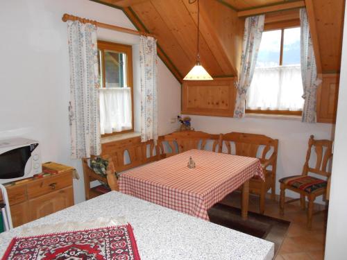 a kitchen with a table and chairs in a room at Ferienhaus Peer in Bad Goisern