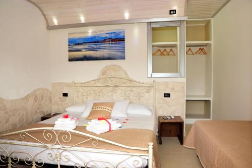 a bedroom with a bed with towels on it at Tenuta Paifer in Otranto