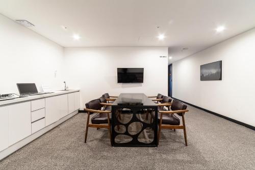 a kitchen and dining room with a table and chairs at Gangneung Tourist Hotel in Gangneung