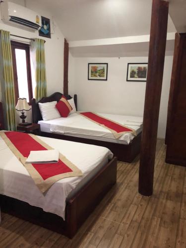 Cama o camas de una habitación en Thavisouk Guesthouse