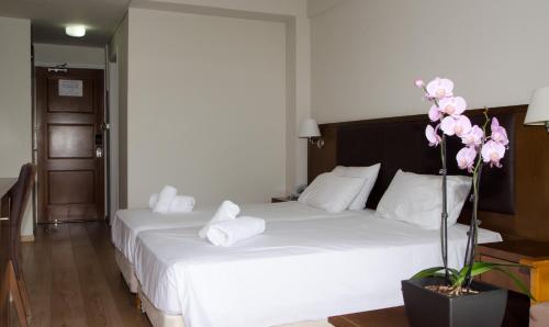 
a hotel room with a bed and a dresser at Rodon Hotel and Resort in Agros
