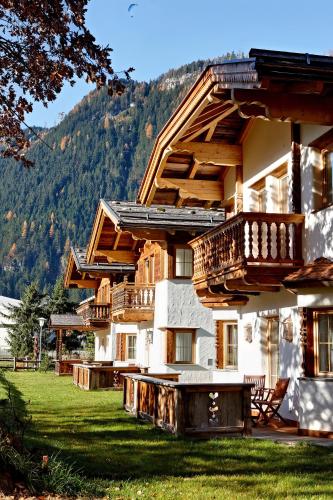 a large building with a balcony on the side of it at S'Dörfl Chalets in Mayrhofen