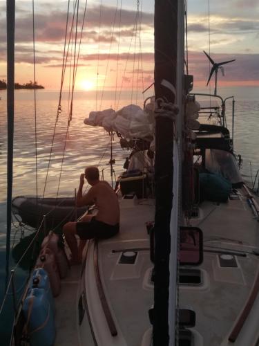 a man sitting on a boat in the water at Play to Live San Blas in El Porvenir