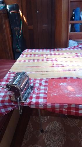 a bed with a red and white checkered table cloth at Play to Live San Blas in El Porvenir