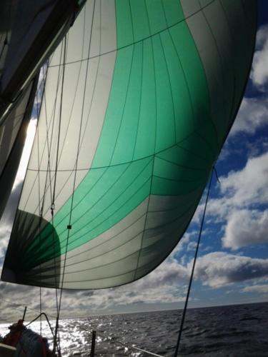 a green and white sail on a boat on the water at Play to Live San Blas in El Porvenir