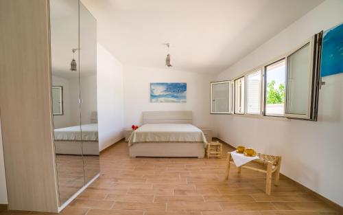 a bedroom with a bed and a glass wall at I Ruscioli in Torre Chianca