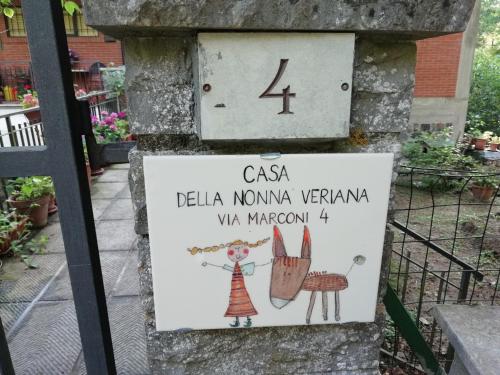 a sign on the side of a building with a sign for a garden at Casa Della Nonna in Radicofani