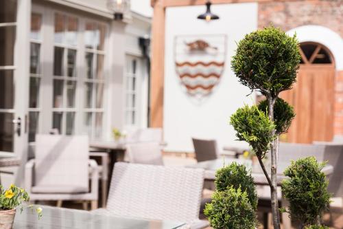 a table with chairs and a tree on a patio at The Beverley Arms Hotel in Beverley