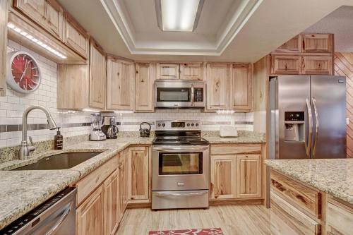 a kitchen with wooden cabinets and stainless steel appliances at BE108 Bridge End Condo in Copper Mountain