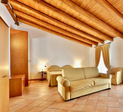 a living room with a couch and a bed at Residence San Giusto in Trieste