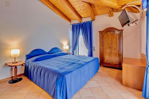 a bedroom with a blue bed and a wooden ceiling at Residence San Giusto in Trieste