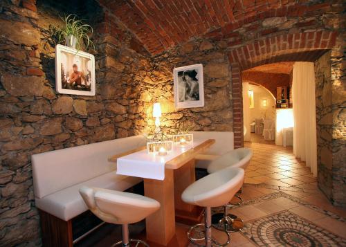 a room with a table and chairs in a stone wall at Hotel-Restaurant Fischerwirt in Gratwein