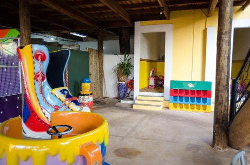 a room with a play area with a clown at Hotel Vale do Café in Machado