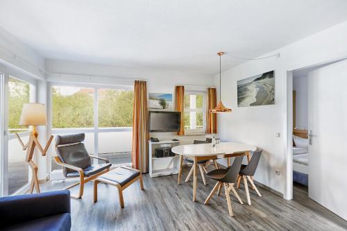 a living room with a table and chairs at A plus Ferienpark Usedom in Ostseebad Koserow