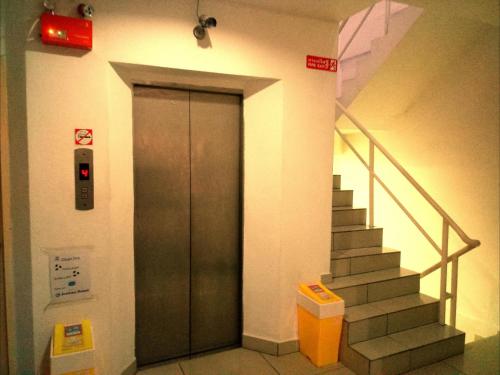 a elevator in a building with a stair case at Jomtien Hostel in Jomtien Beach