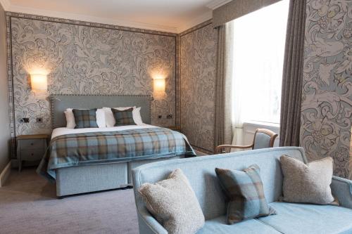 a bedroom with a bed and a couch at The Beverley Arms Hotel in Beverley