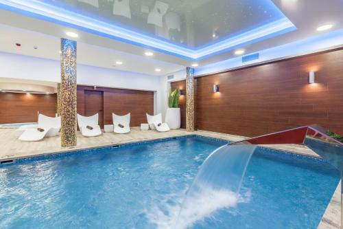 a pool in a hotel room with a swimming pool at Hotel Beskid in Nowy Sącz