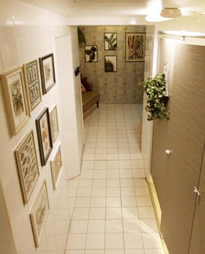 a hallway with framed pictures on the walls and a hallway with a hallway at Skanstulls Boutique Hostel in Stockholm