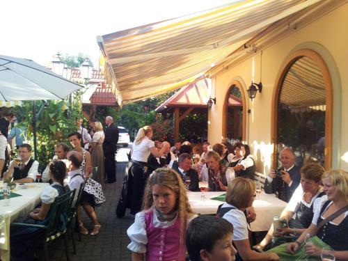 a group of people sitting at tables in a restaurant at Hotel-Restaurant Fischerwirt in Gratwein