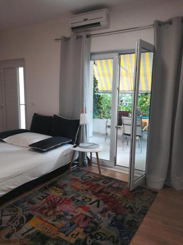 a bedroom with a bed and sliding glass doors with a patio at Centar Guest house in Makarska