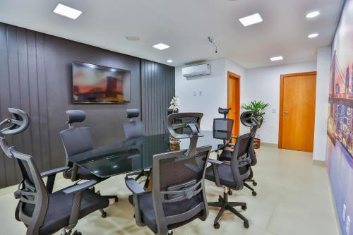 an office with a desk and chairs in a room at Golden Lis Hotel Boutique in Goiânia