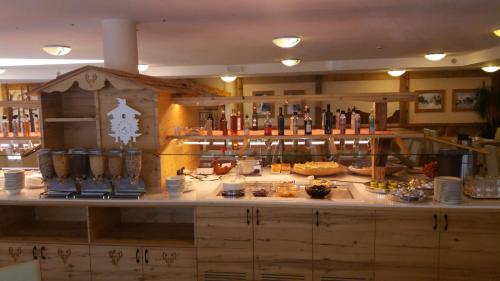 a kitchen with a counter with food on it at Hotel Stella Montis in Campitello di Fassa