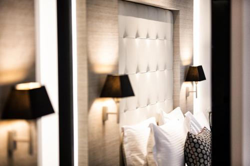 a hotel room with two lamps on the wall at Antigon Urban Chic Hotel, Thessaloniki in Thessaloniki