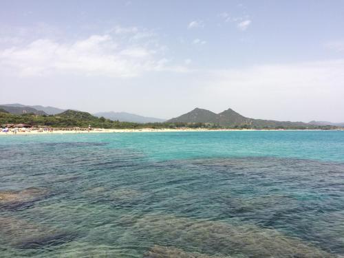 a view of a beach with mountains in the background at Villa Antonella in Villasimius