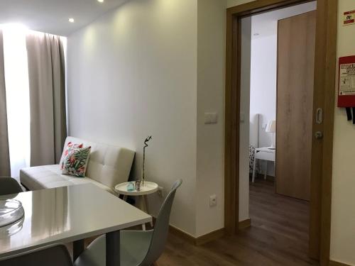 a living room with a white couch and a table at Povoa do Mar in Póvoa de Varzim