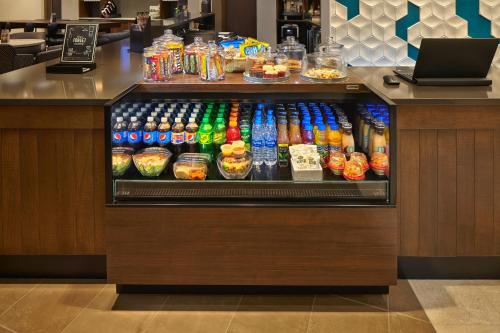 a drink cooler in a restaurant with drinks at Hyatt Place Warwick/Providence Airport in Warwick