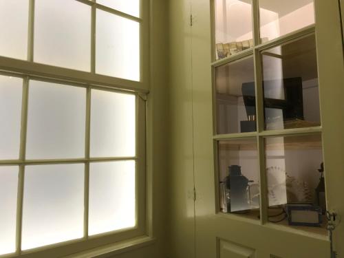 a room with two windows and a door at Povoa do Mar in Póvoa de Varzim