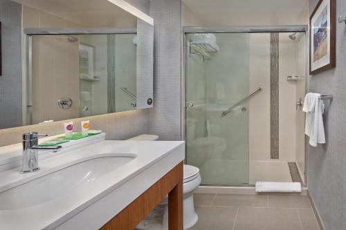 a bathroom with a sink and a shower and a toilet at Hyatt Place Warwick/Providence Airport in Warwick