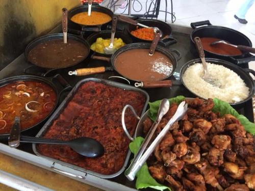 a bunch of different types of food on a stove at Hotel Vale do Café in Machado