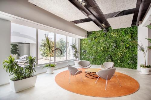 an office with a green wall of plants at Planet One Hotel in El Arenal