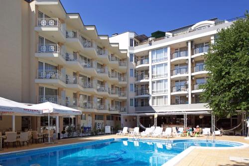 a hotel with a swimming pool in front of a building at Karlovo Hotel in Sunny Beach
