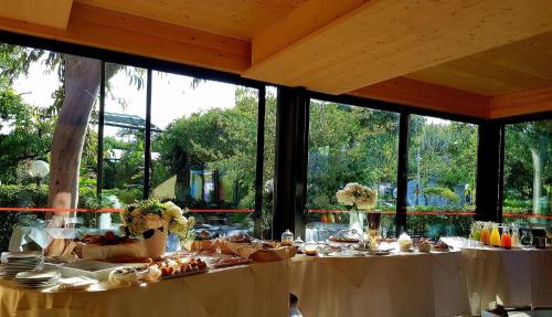 a table with white table cloths and food on it at Villaggio Dei Fiori in Sanremo