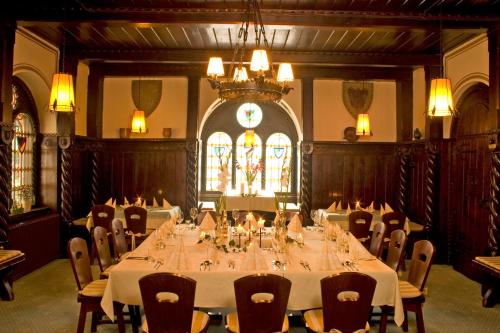 a large dining room with a long table and chairs at Hotel-Restaurant Fischerwirt in Gratwein
